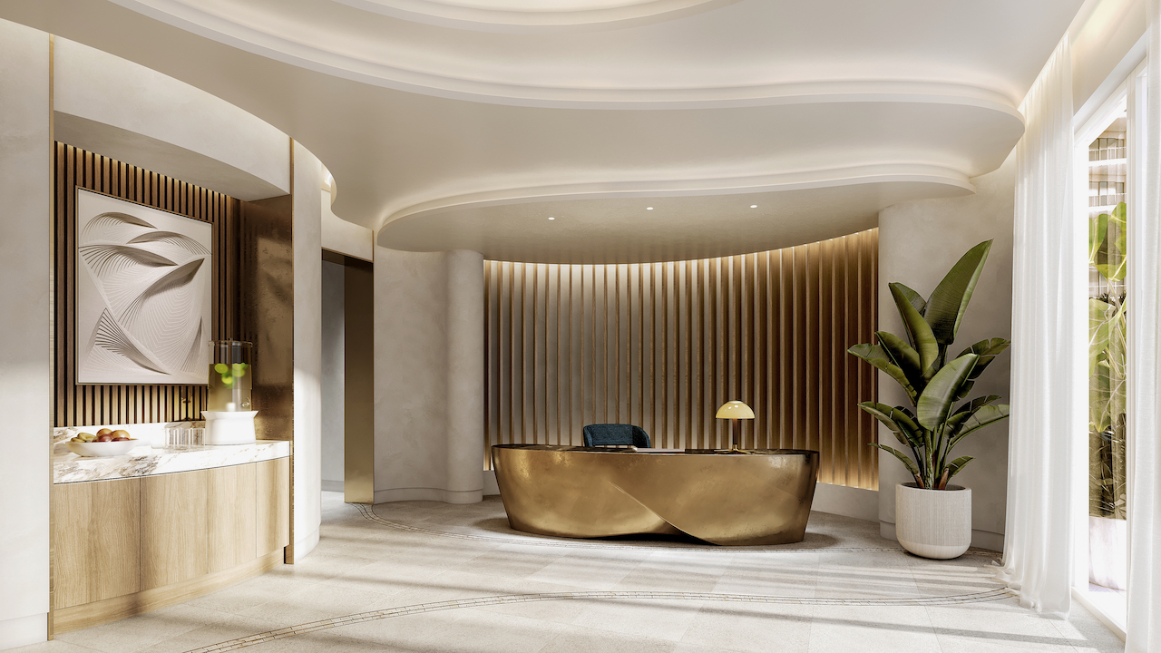 Grand lobby with sculptural gold reception desk and tropical decor